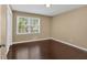 Bedroom featuring hardwood floors and a window with natural light at 2144 Kennesaw Due West Nw Rd, Kennesaw, GA 30152