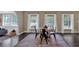 Dining room showcasing hardwood floors, large windows, with an open archway into the living room at 2144 Kennesaw Due West Nw Rd, Kennesaw, GA 30152