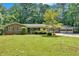 Charming brick home with a spacious front yard, mature trees, a two car garage, and ample parking at 2144 Kennesaw Due West Nw Rd, Kennesaw, GA 30152