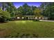 Charming brick home with a spacious front yard and mature trees offering shade and curb appeal at 2144 Kennesaw Due West Nw Rd, Kennesaw, GA 30152