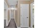 Hallway with hardwood flooring, neutral walls, and multiple doorways leading to various rooms at 2144 Kennesaw Due West Nw Rd, Kennesaw, GA 30152