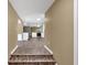 Long hallway leads to updated kitchen with modern wood look flooring and neutral walls at 2144 Kennesaw Due West Nw Rd, Kennesaw, GA 30152
