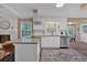 Bright open concept kitchen features granite countertops, stainless steel appliances, and updated white cabinets at 2144 Kennesaw Due West Nw Rd, Kennesaw, GA 30152