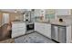 Bright kitchen with stainless steel appliances, granite counters and white cabinets offers a fresh, modern feel at 2144 Kennesaw Due West Nw Rd, Kennesaw, GA 30152