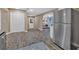 Open floorplan features stainless steel refrigerator, neutral wall paint, and modern wood-look floors at 2144 Kennesaw Due West Nw Rd, Kennesaw, GA 30152