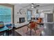 Open floorplan living room flows into kitchen with painted brick fireplace and stylish decor at 2144 Kennesaw Due West Nw Rd, Kennesaw, GA 30152