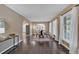 Bright living room showcasing hardwood floors, large windows, and open archways leading to other living spaces at 2144 Kennesaw Due West Nw Rd, Kennesaw, GA 30152