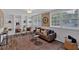 Bright living room features custom built-ins, decorative rug, and large windows for ample natural light at 2144 Kennesaw Due West Nw Rd, Kennesaw, GA 30152