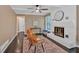 Cozy living room boasts painted brick fireplace, ceiling fan, and updated furniture at 2144 Kennesaw Due West Nw Rd, Kennesaw, GA 30152