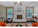 Inviting living room with painted brick fireplace, ceiling fan, and modern furniture at 2144 Kennesaw Due West Nw Rd, Kennesaw, GA 30152