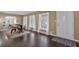 Bright living room showcasing hardwood floors, large windows, and an entry doorway to the home at 2144 Kennesaw Due West Nw Rd, Kennesaw, GA 30152