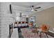 Open concept living room with ceiling fan, fireplace, and view into adjacent kitchen at 2144 Kennesaw Due West Nw Rd, Kennesaw, GA 30152