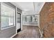 Bright sunroom featuring updated floors and paneled walls at 2144 Kennesaw Due West Nw Rd, Kennesaw, GA 30152