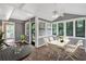 Bright sunroom features new floors, paneled walls and ample seating at 2144 Kennesaw Due West Nw Rd, Kennesaw, GA 30152
