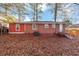Brick house with a backyard filled with brown leaves at 2259 Nelms Sw Dr, Atlanta, GA 30315