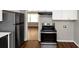 Updated kitchen with stainless steel appliances and dark wood flooring at 2259 Nelms Sw Dr, Atlanta, GA 30315
