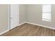 Empty bedroom with wood-look floors and neutral walls at 1162 Misty Meadows Xing, Hampton, GA 30228