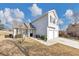 Two-story house with gray siding, two car garage and landscaping at 1162 Misty Meadows Xing, Hampton, GA 30228