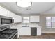 Bright kitchen with stainless steel appliances and white cabinets at 1162 Misty Meadows Xing, Hampton, GA 30228