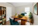 Home office with wood desk and teal chairs at 1162 Misty Meadows Xing, Hampton, GA 30228