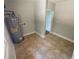 Laundry room with tile flooring and water heater at 774 Mill Rd, Mcdonough, GA 30253