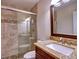 Updated bathroom with granite countertop, walk-in shower, and tiled floor at 1326 Nantahala Ne Trl, Marietta, GA 30062