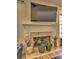 Fireplace with built-in shelving and large TV above at 1326 Nantahala Ne Trl, Marietta, GA 30062