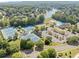 Aerial view of a community with tennis courts, a pool, and recreational area surrounded by trees and homes at 2960 Millwater Xing, Dacula, GA 30019