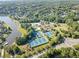 Aerial view of a community with tennis courts, a pool, and recreational area surrounded by trees and homes at 2960 Millwater Xing, Dacula, GA 30019