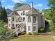 Beautiful home exterior featuring a spacious yard, private balcony, and meticulously maintained landscaping at 2960 Millwater Xing, Dacula, GA 30019