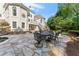 Elegant backyard patio with a stone table and chairs for outdoor dining at 2960 Millwater Xing, Dacula, GA 30019