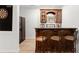 Charming bar area featuring wood cabinetry, a dart board, and stylish seating, ideal for casual gatherings at 2960 Millwater Xing, Dacula, GA 30019
