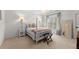 Cozy bedroom with a four-poster bed, soft lighting, and a neutral color palette at 2960 Millwater Xing, Dacula, GA 30019