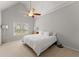 Airy bedroom with a ceiling fan, vaulted ceiling, and natural light from a large window at 2960 Millwater Xing, Dacula, GA 30019