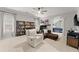 Spacious bonus room with neutral colors, comfortable seating, and ample shelving for collectibles at 2960 Millwater Xing, Dacula, GA 30019