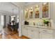 Butler's pantry with glass front cabinets, marble countertop, and wine refrigerator at 2960 Millwater Xing, Dacula, GA 30019
