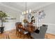 Elegant dining room with hardwood floors, chandelier, and stylish decor at 2960 Millwater Xing, Dacula, GA 30019