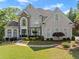 Stunning two-story home boasts a manicured lawn and beautiful landscaping at 2960 Millwater Xing, Dacula, GA 30019