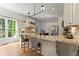 Bright eat-in kitchen features a large island, stone countertops and stainless steel appliances at 2960 Millwater Xing, Dacula, GA 30019