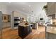 Open concept kitchen with stainless appliances, center island, and breakfast nook at 2960 Millwater Xing, Dacula, GA 30019