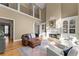 Large living room with soaring ceilings, fireplace, and comfortable seating area at 2960 Millwater Xing, Dacula, GA 30019