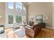 Bright living room with soaring windows, hardwood floors, and comfortable seating at 2960 Millwater Xing, Dacula, GA 30019