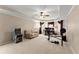 Spacious living area featuring neutral walls, a ceiling fan, and a cozy seating area with a sofa and exercise equipment at 2960 Millwater Xing, Dacula, GA 30019