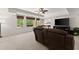 Bright living room with a large TV, comfortable seating, and natural light streaming through the windows at 2960 Millwater Xing, Dacula, GA 30019