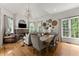 Inviting living room with fireplace, large windows, and open concept to dining area at 2960 Millwater Xing, Dacula, GA 30019