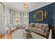 Stylish living room with elegant furniture, large windows, and blue accent wall at 2960 Millwater Xing, Dacula, GA 30019