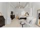 Spacious main bedroom featuring tray ceilings, sitting area, ceiling fan, and ample natural light at 2960 Millwater Xing, Dacula, GA 30019