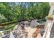 Charming stone patio with outdoor seating area overlooking lush green trees at 2960 Millwater Xing, Dacula, GA 30019