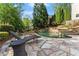 Relaxing pool area with stone patio, lounge chairs, and lush landscaping at 2960 Millwater Xing, Dacula, GA 30019