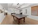 Spacious recreation room featuring a ping pong table and an open layout with wood flooring and ample natural light at 2960 Millwater Xing, Dacula, GA 30019